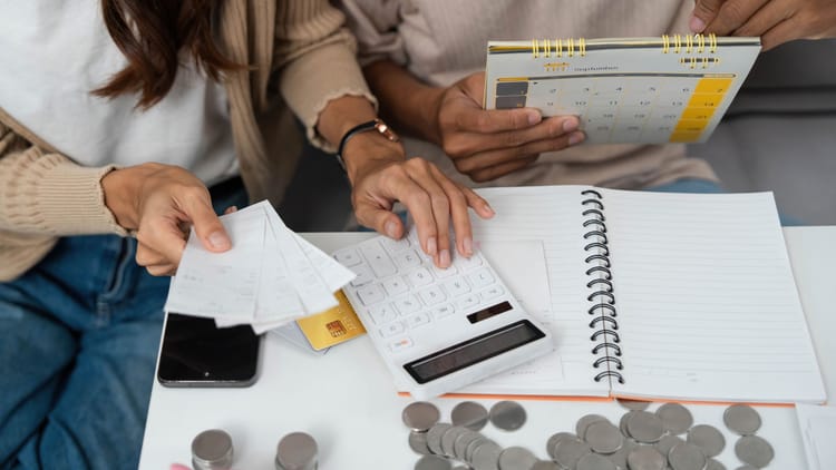 a couple budgeting together and managing their finances while calculating the cost of full time rv living